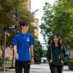 PMP banner two students walking under trees