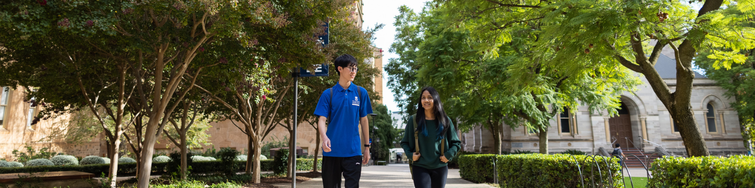 two students walking towards camera